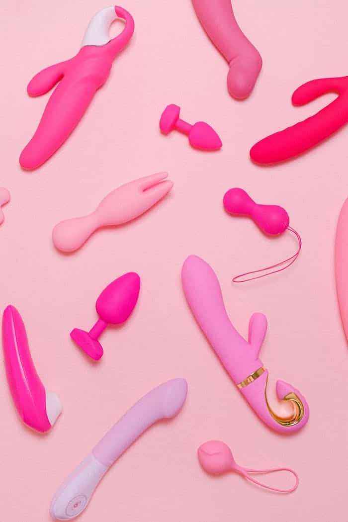 gallery-02 Explore a variety of pink adult toys including vibrators, silicone accessories, and more on a pastel background.